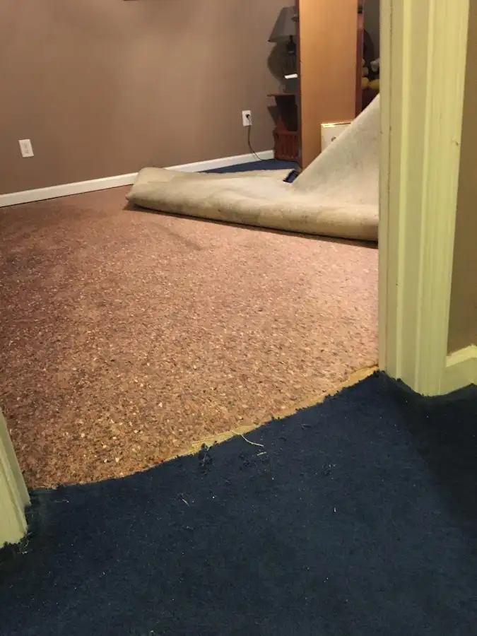 Carpet pad removal revealing water damage during Water Mitigation Services in Porters Neck