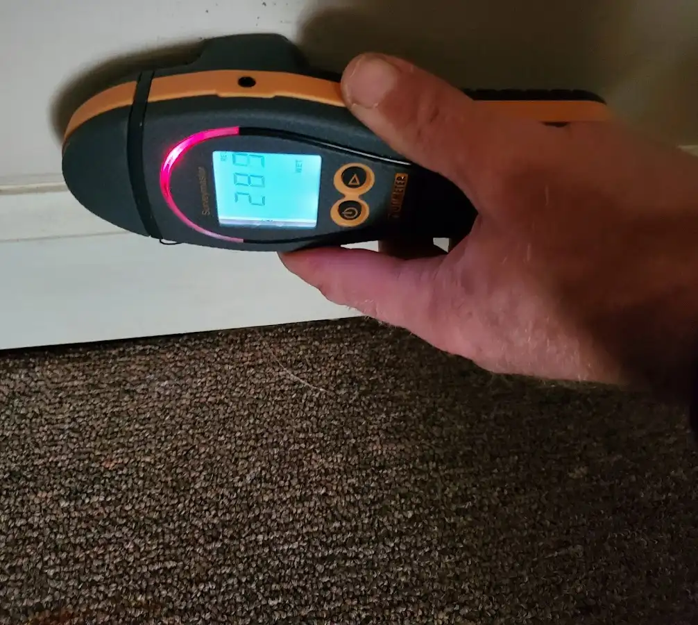 Moisture detection at baseboard during Storm Damage Restoration in Porters Neck